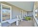 Wooden front porch with chairs and plants at 144A Celebrity Dairy Way, Siler City, NC 27344