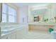Bathroom with double vanity, soaking tub, and tiled floor at 144A Celebrity Dairy Way, Siler City, NC 27344