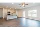 Open concept kitchen and living area with an island, hardwood floors, and a view to the backyard at 122 Vega Loop # 61, Sanford, NC 27330