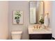 Modern powder room with dark vanity and gold fixtures at 85 Harvest View Way, Franklinton, NC 27525