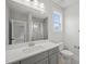 Modern bathroom with gray vanity, a large mirror, and shower at 85 Harvest View Way, Franklinton, NC 27525