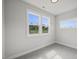 Bright bedroom with grey carpet and two windows at 85 Harvest View Way, Franklinton, NC 27525