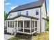 Two story home with white siding, screened porch, and landscaping at 85 Harvest View Way, Franklinton, NC 27525