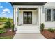 Inviting front porch with double doors and white brick steps at 85 Harvest View Way, Franklinton, NC 27525