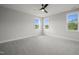 Spacious bedroom with grey carpet and three windows at 85 Harvest View Way, Franklinton, NC 27525