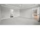 Large bedroom with grey carpet, an ensuite bathroom, and access to another room at 85 Harvest View Way, Franklinton, NC 27525