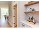 Built-in bar with marble countertop and wooden shelving at 85 Harvest View Way, Franklinton, NC 27525
