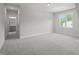 Spacious bedroom with plush carpeting and large window offering natural light at 85 Harvest View Way, Franklinton, NC 27525