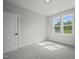 Spacious bedroom with grey carpet and two windows at 85 Harvest View Way, Franklinton, NC 27525