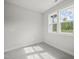 Bright bedroom with grey carpet and two windows at 85 Harvest View Way, Franklinton, NC 27525