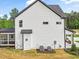 White house exterior with screened porch, landscaping, and two-car garage at 85 Harvest View Way, Franklinton, NC 27525