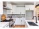 Modern kitchen with white cabinets and gas range at 85 Harvest View Way, Franklinton, NC 27525