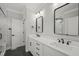 Modern bathroom with double vanity, black matte fixtures, and a large mirror at 85 Harvest View Way, Franklinton, NC 27525