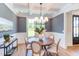 Formal dining room with a round table, chandelier, and gray walls at 85 Harvest View Way, Franklinton, NC 27525