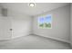 Bright bedroom with grey carpet and window at 85 Harvest View Way, Franklinton, NC 27525