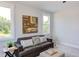 Sitting room with couch, ottoman, and large wall art at 85 Harvest View Way, Franklinton, NC 27525