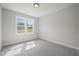 Bright bedroom with grey carpet and two windows at 85 Harvest View Way, Franklinton, NC 27525
