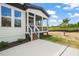 Screened porch with wooden stairs and concrete patio at 85 Harvest View Way, Franklinton, NC 27525