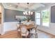 Formal dining room with a round table, chandelier, and gray walls at 85 Harvest View Way, Franklinton, NC 27525