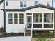 Rear view of house showing a screened porch and landscaping at 85 Harvest View Way, Franklinton, NC 27525