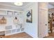 White built-in bench with cubbies and hooks in the entryway at 85 Harvest View Way, Franklinton, NC 27525