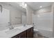 Bathroom with double vanity and a bathtub, offering convenience at 530 Husketh Rd, Youngsville, NC 27596