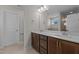 Double vanity bathroom with dark brown cabinets and quartz countertops at 530 Husketh Rd, Youngsville, NC 27596