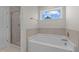 Bathroom with a shower and garden tub, offering a relaxing atmosphere at 530 Husketh Rd, Youngsville, NC 27596
