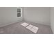 Bright bedroom with carpet flooring and a window overlooking trees at 530 Husketh Rd, Youngsville, NC 27596