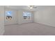 Well-lit bedroom featuring carpet floors and a view of the neighborhood at 530 Husketh Rd, Youngsville, NC 27596