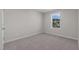 Spacious bedroom with carpet floors and a window with a neighborhood view at 530 Husketh Rd, Youngsville, NC 27596