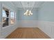 Bright dining room with light blue walls, crown molding, and hardwood floors at 530 Husketh Rd, Youngsville, NC 27596