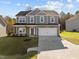 Two-story house with gray siding, white garage door, and landscaped lawn at 530 Husketh Rd, Youngsville, NC 27596