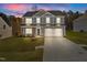 Two-story house with gray siding, white garage door, and landscaped lawn at 530 Husketh Rd, Youngsville, NC 27596