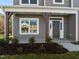 Covered front porch with dark brown columns and a dark-colored front door at 530 Husketh Rd, Youngsville, NC 27596