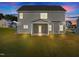 Gray house exterior with backyard at night at 530 Husketh Rd, Youngsville, NC 27596
