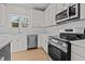 Modern kitchen with white cabinets, stainless steel appliances, and white countertops at 530 Husketh Rd, Youngsville, NC 27596
