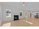 Open living room with hardwood floors, fireplace, and kitchen view at 530 Husketh Rd, Youngsville, NC 27596