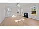 Spacious living room with hardwood floors, fireplace, and multiple windows at 530 Husketh Rd, Youngsville, NC 27596