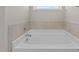 Clean bathroom featuring a bathtub with tile surround at 545 Husketh Rd, Youngsville, NC 27596