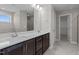 Double vanity bathroom with a large mirror and walk-in shower at 545 Husketh Rd, Youngsville, NC 27596