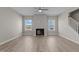 Living room with fireplace, ceiling fan, and hardwood floors at 545 Husketh Rd, Youngsville, NC 27596