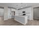 Modern kitchen with white cabinets, quartz countertops, and an island at 545 Husketh Rd, Youngsville, NC 27596