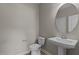 Powder room with pedestal sink and oval mirror at 545 Husketh Rd, Youngsville, NC 27596