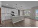 Open concept kitchen with white cabinets, island, and breakfast area at 545 Husketh Rd, Youngsville, NC 27596