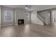 Spacious living room with hardwood floors, fireplace, and staircase at 545 Husketh Rd, Youngsville, NC 27596