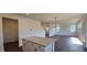 Open kitchen with granite island, white cabinets, and hardwood floors at 1341 Underbrush Dr, Durham, NC 27703