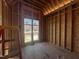 New bedroom with wood framing, windows installed, and flooring at 4905 Hidden Pasture Way, Zebulon, NC 27597