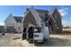 Craftsman style home with brick and white accents, a metal roof, and a large front yard at 4909 Hidden Pasture Way, Zebulon, NC 27597