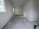 Empty garage interior with white walls and exposed brick at 4909 Hidden Pasture Way, Zebulon, NC 27597